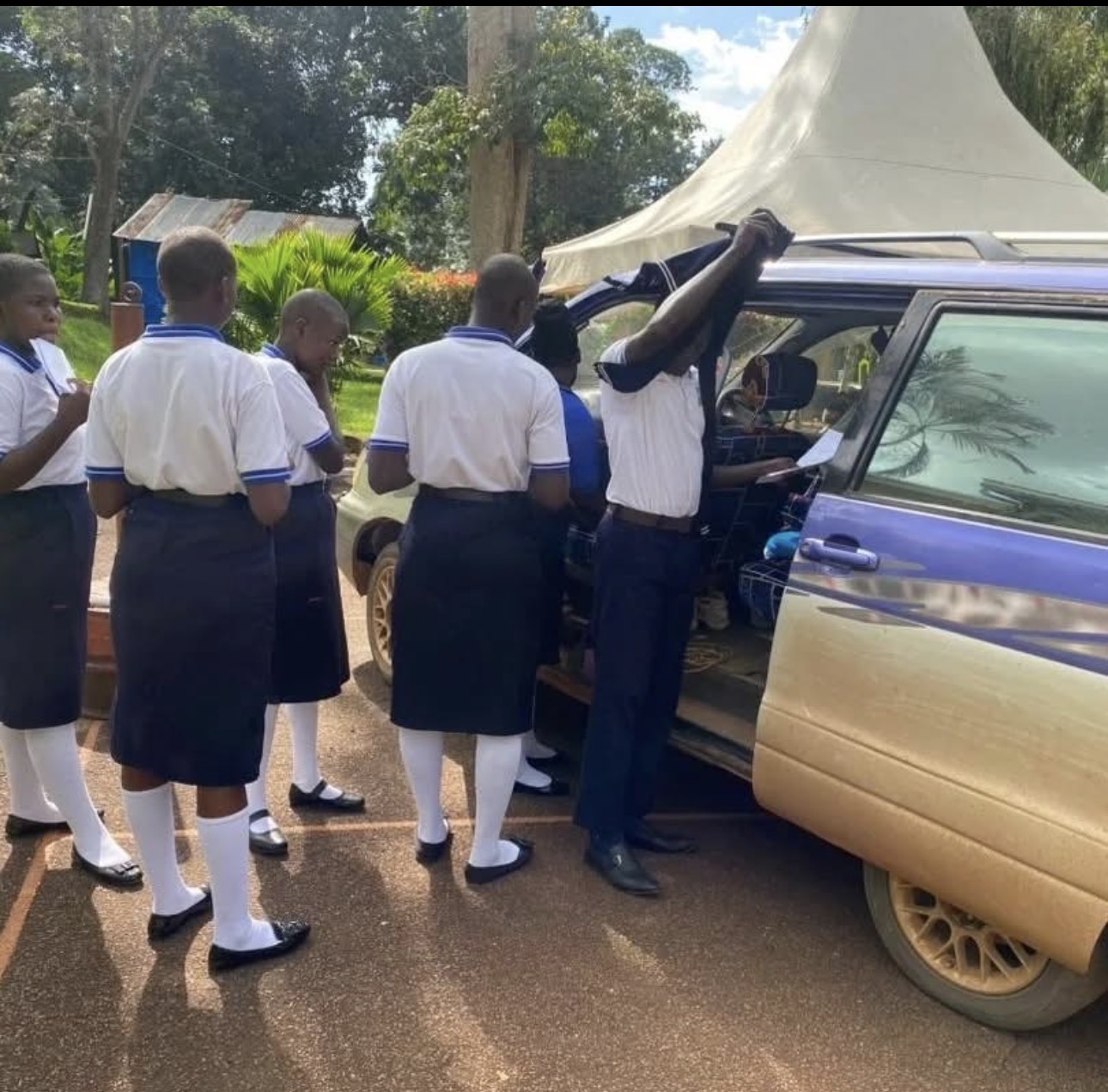 Secondary students in uniform preparing for a school trip