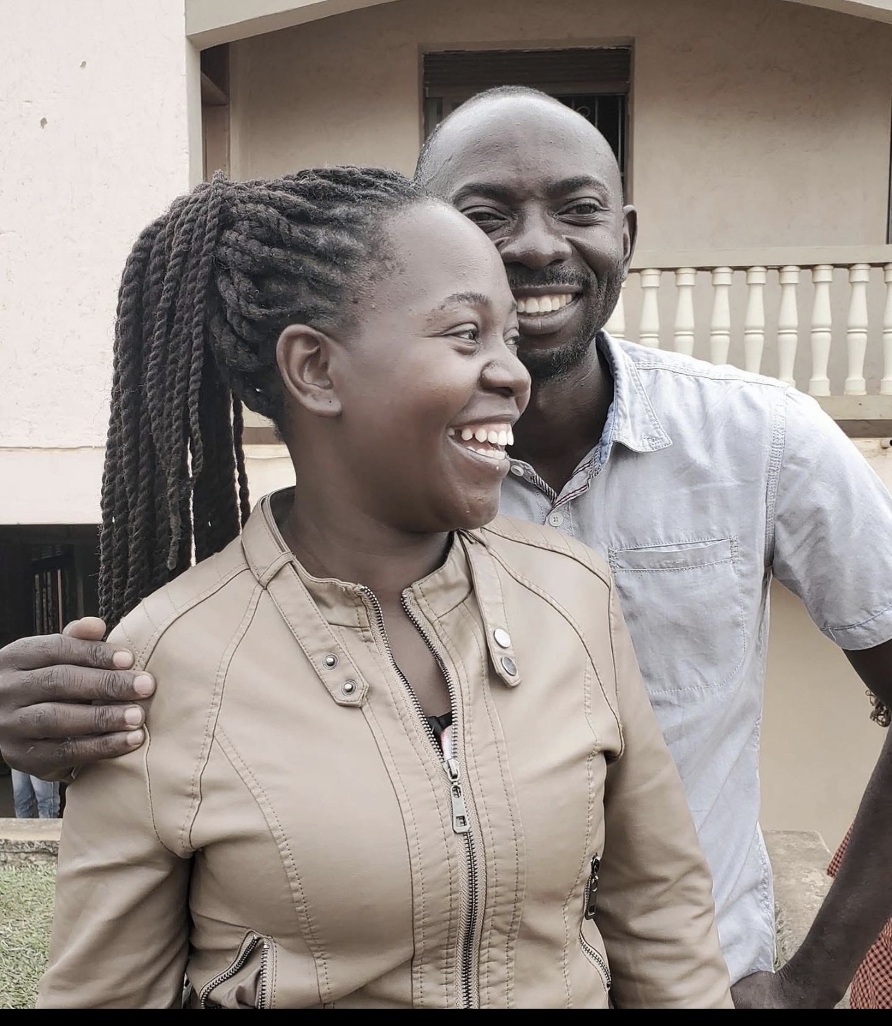Two staff members sharing a joyful moment
