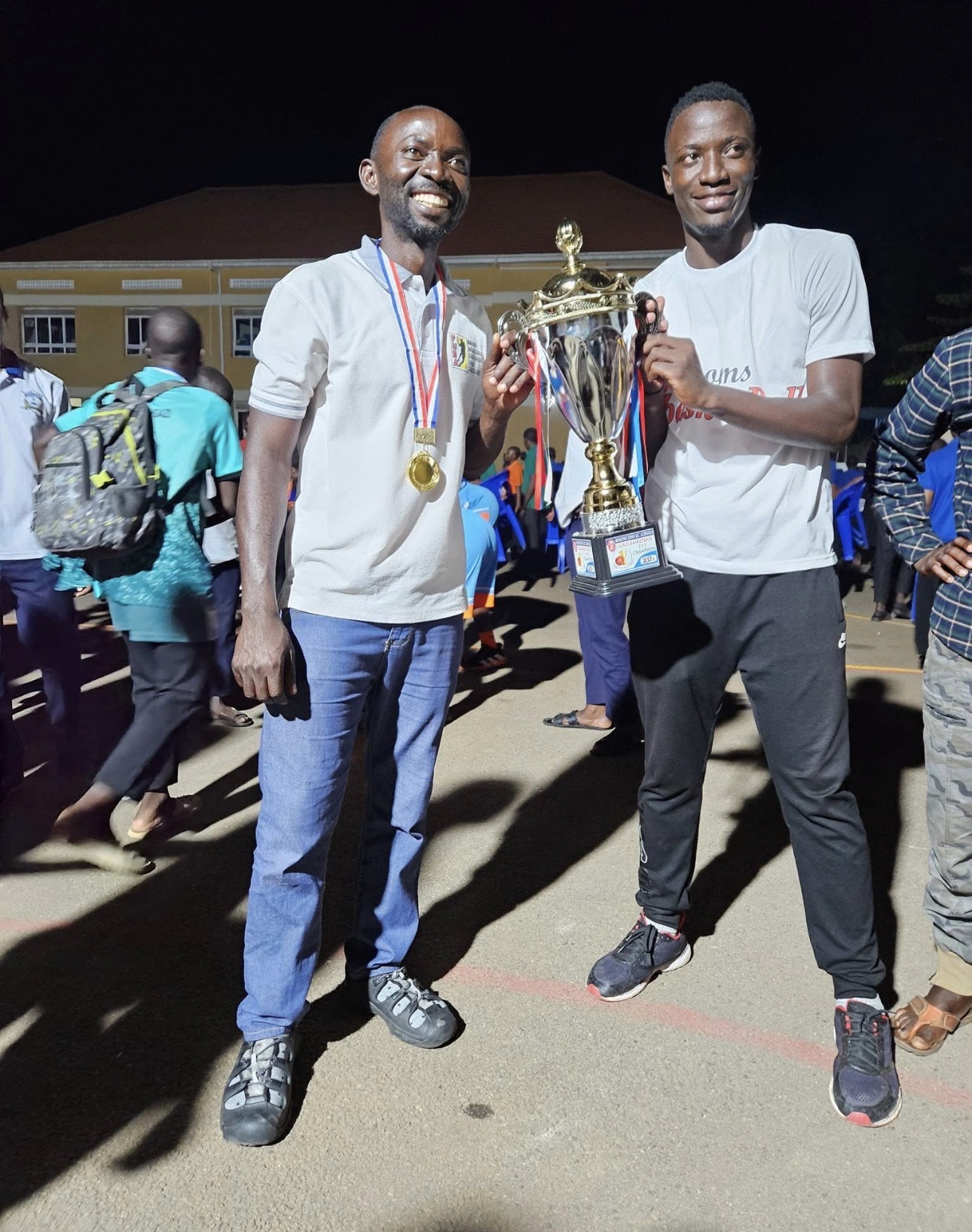 Coach and player holding the championship trophy
