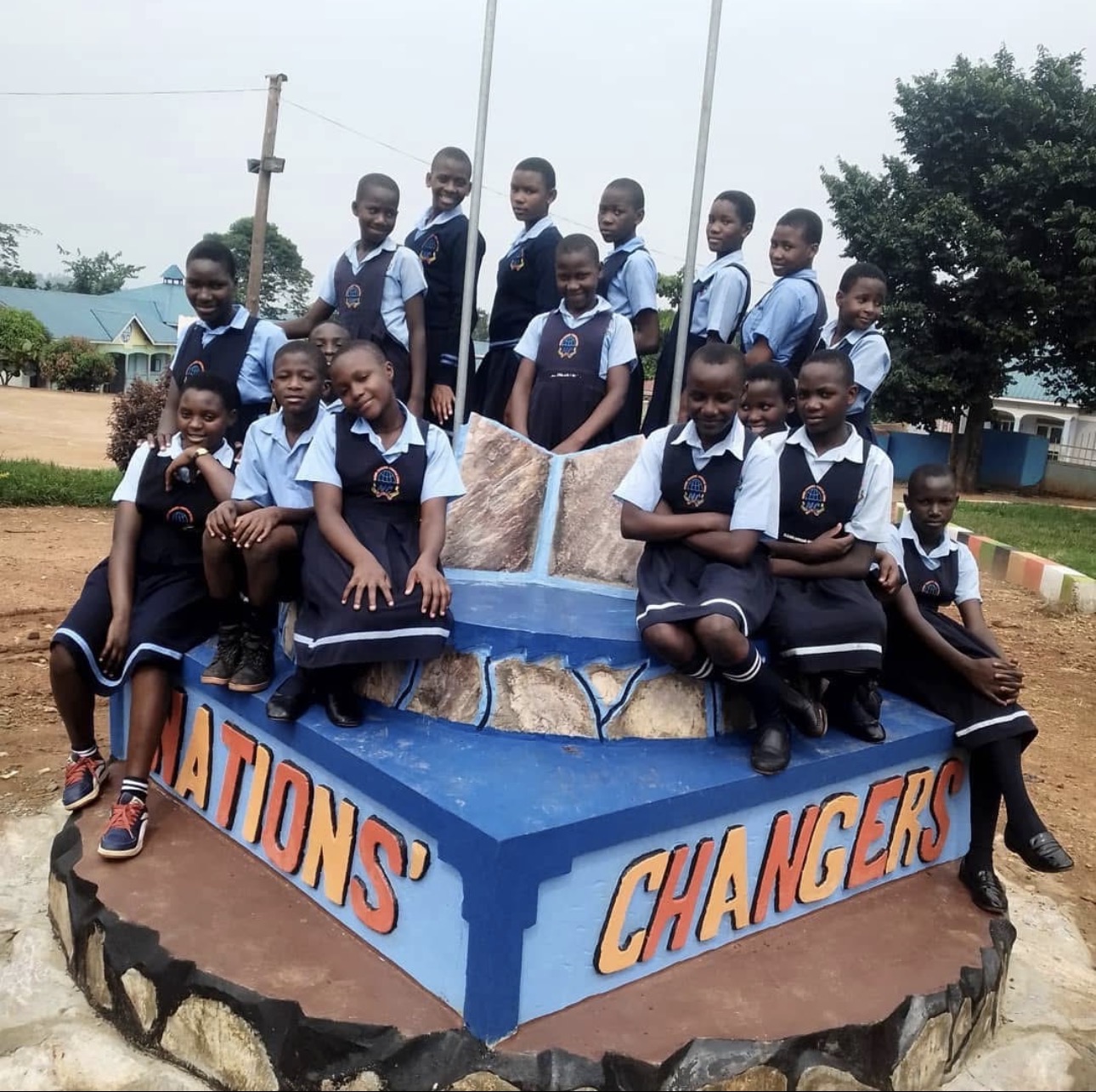 Nations' Changers students gathered around the school's monument